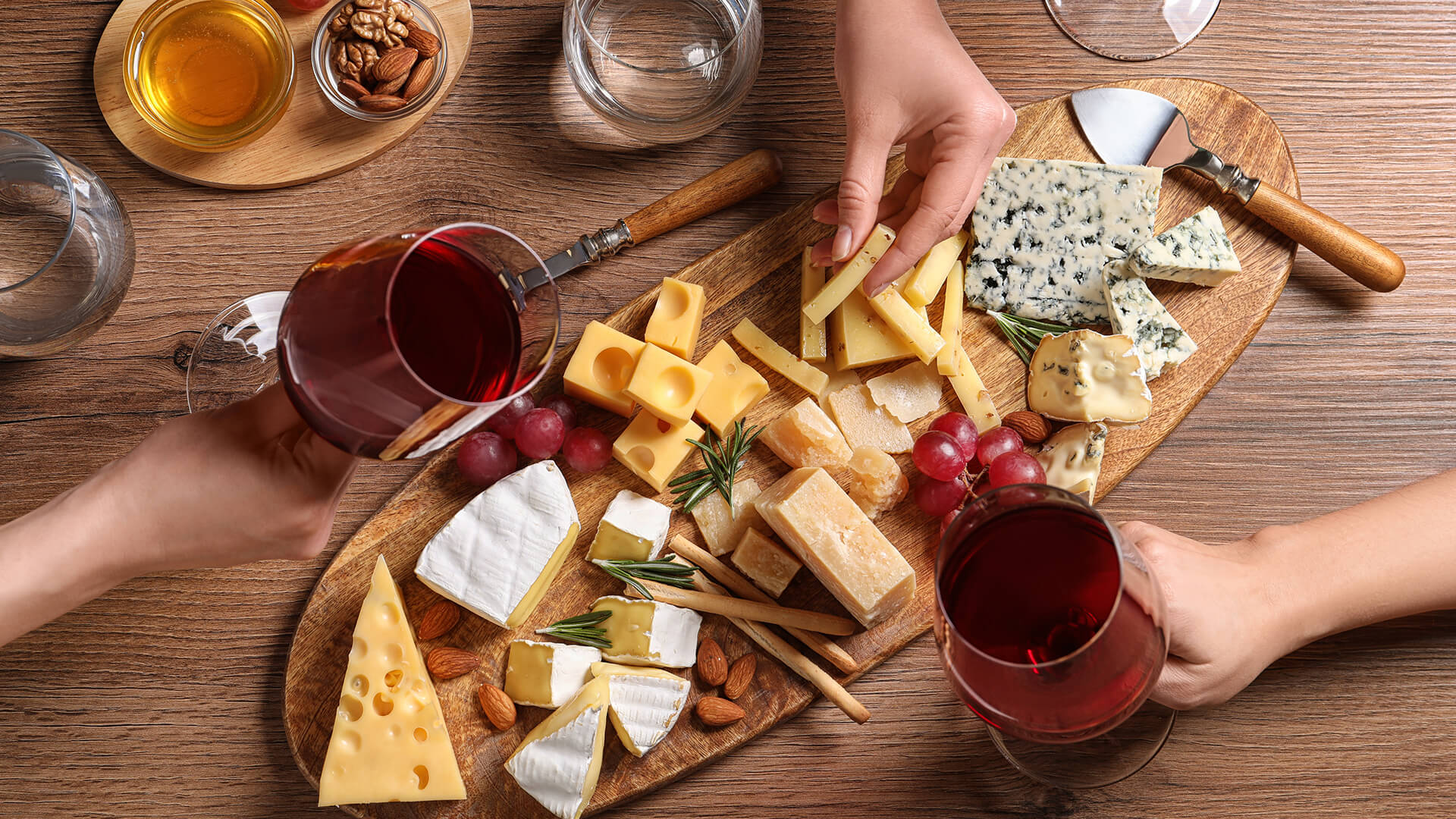 Red wine paired with an elevated cheese board of soft, hard, and aged cheeses. 